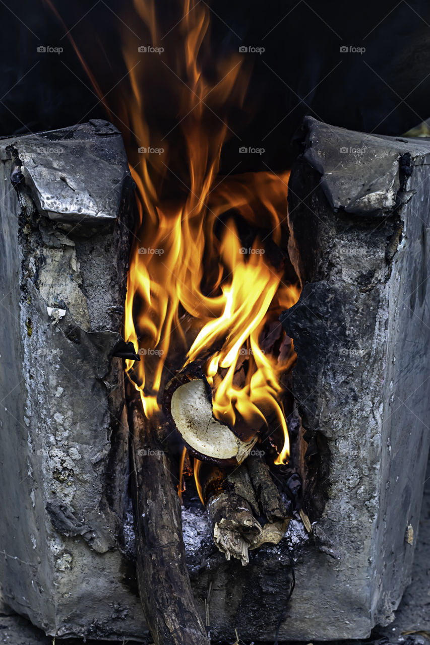 Yellow flame on the log in the oven.