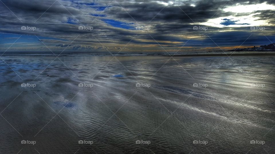 Clouds reflected on beach