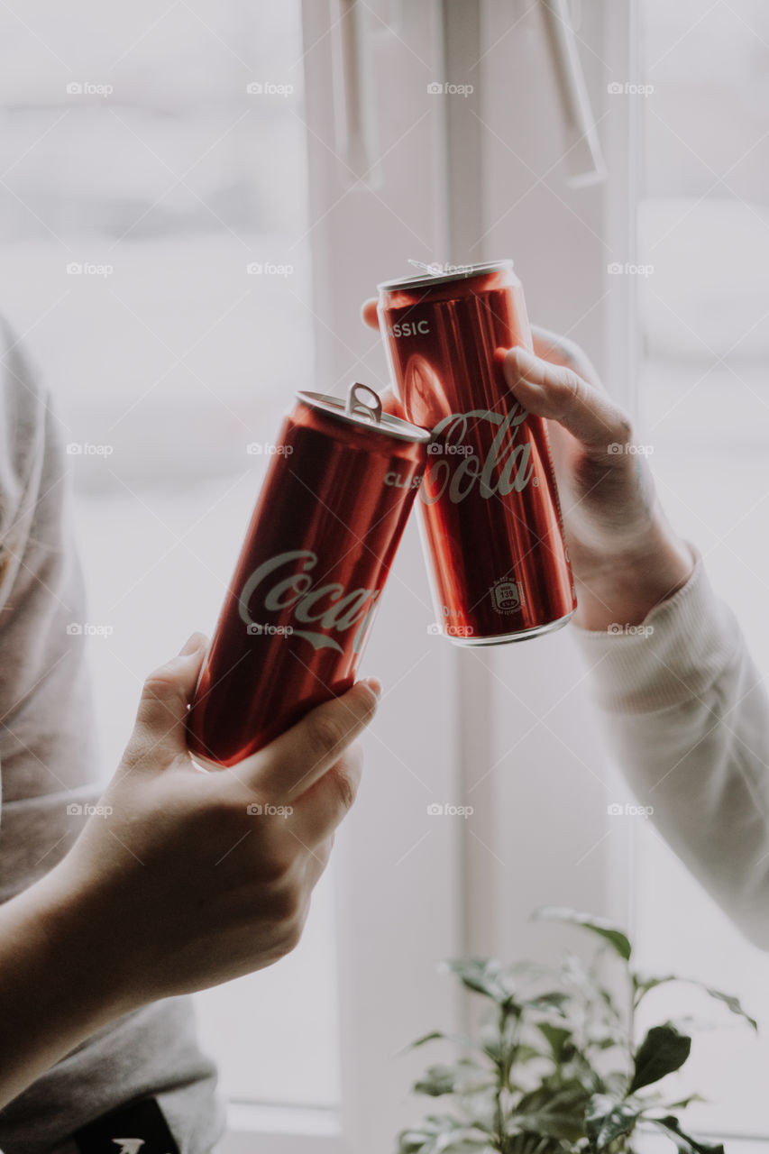 coca cola in hands / cheers with coca cola