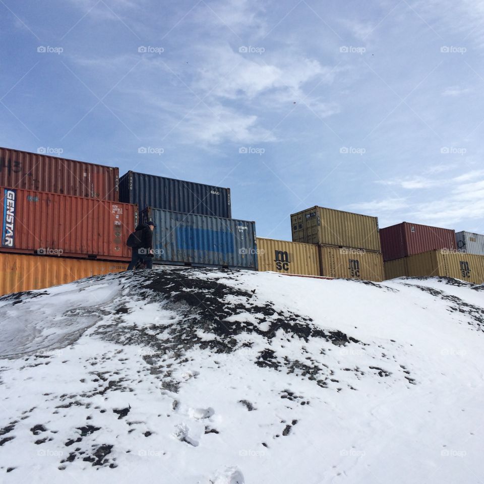 Industrial container landscape with snow and blue sky