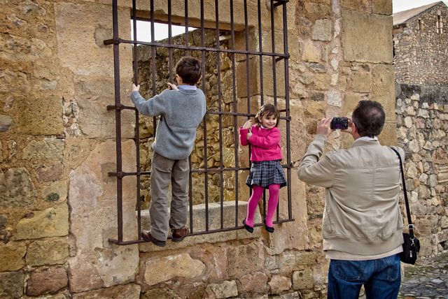 A man takes a photo of his kids 