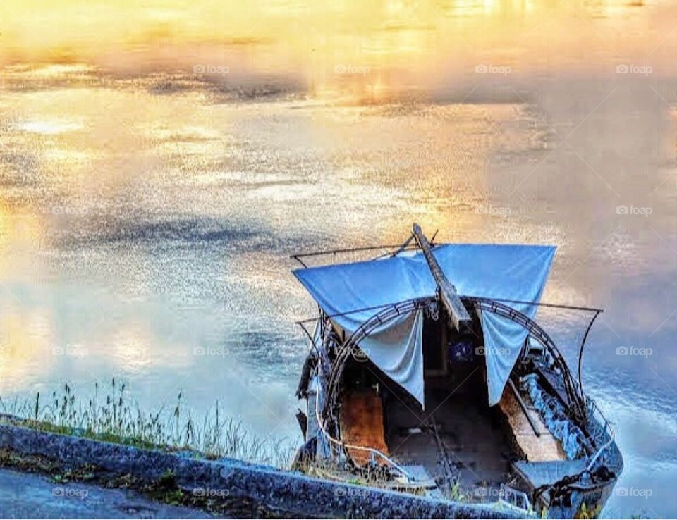 Small ferry-boat moored at dusk along the Loire