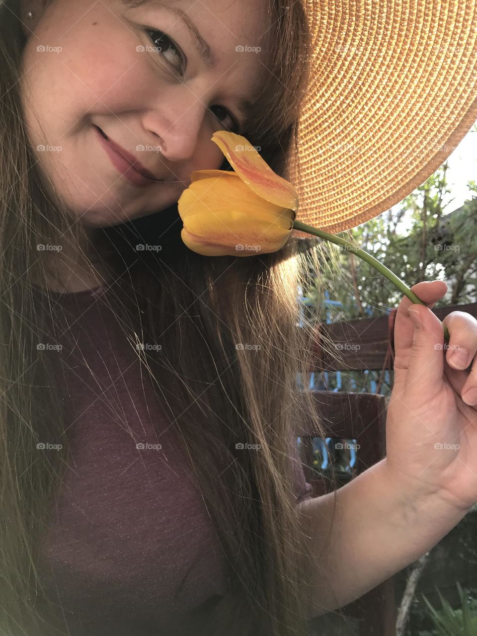 A girl with a yellow flower