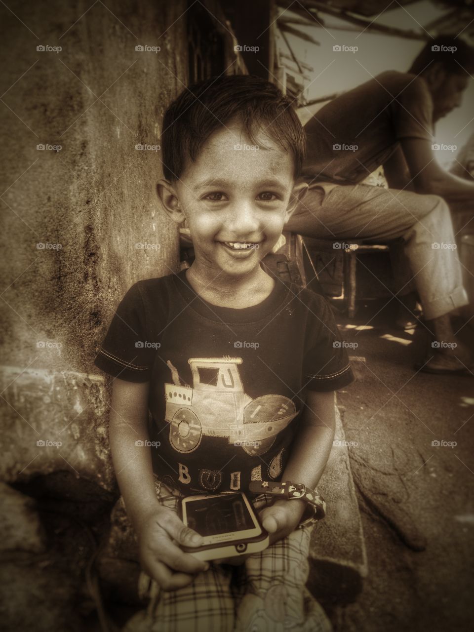 Portrait of boy holding cellphone