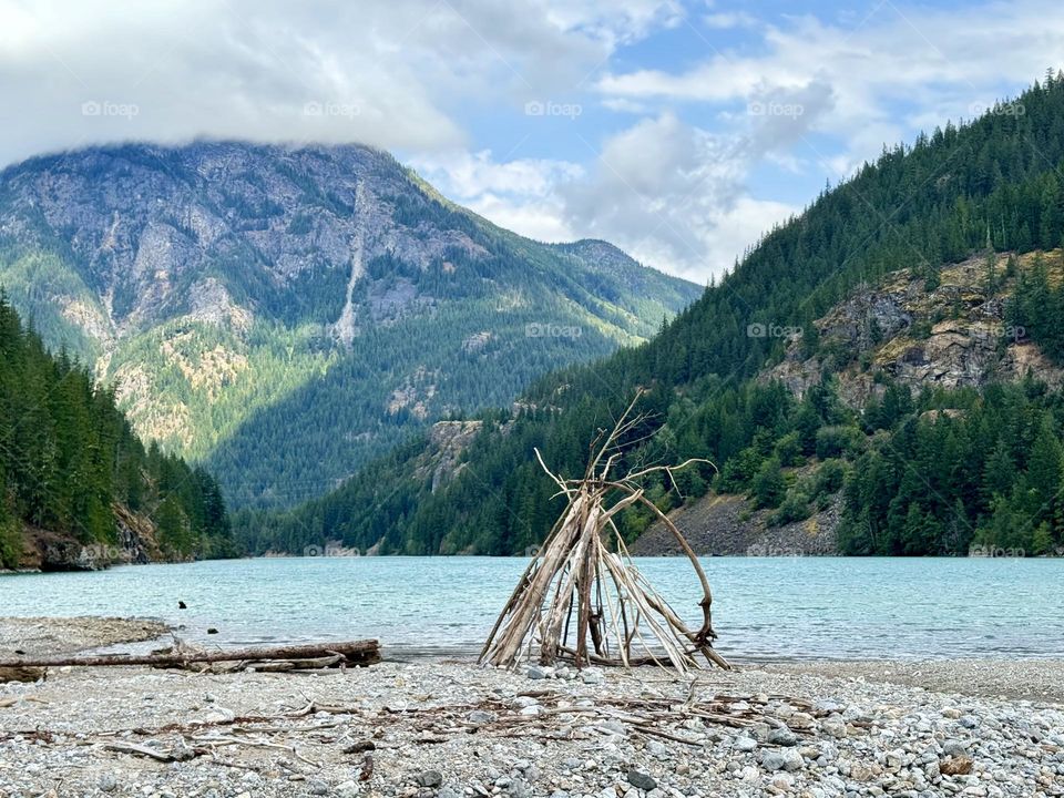 Mountain lake landscape with wooden hut