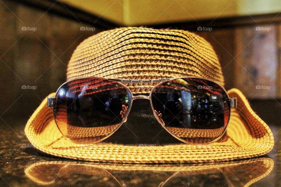 Hipster Shades. Sunglasses resting on a hat