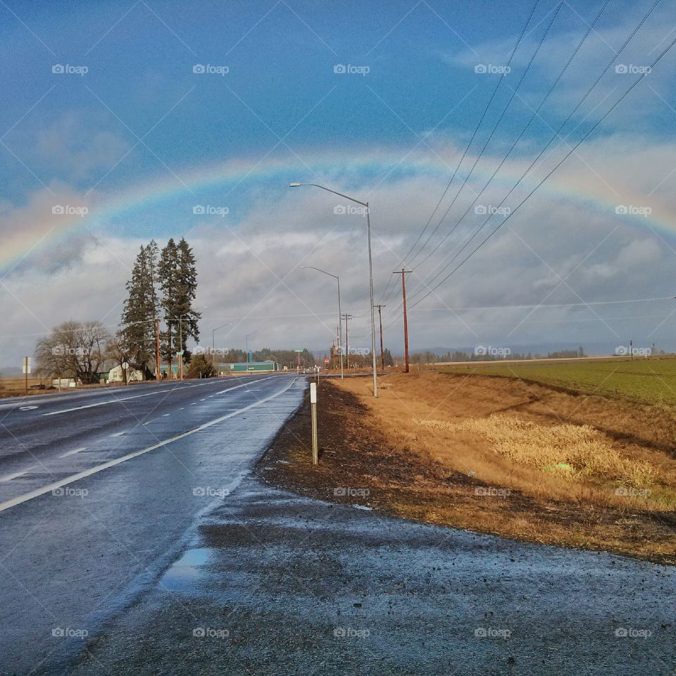 Rainbow over Hillsboro. I was driving a back road in Hillsboro Oregon and saw a beautiful rainbow pulled over and took this photo.