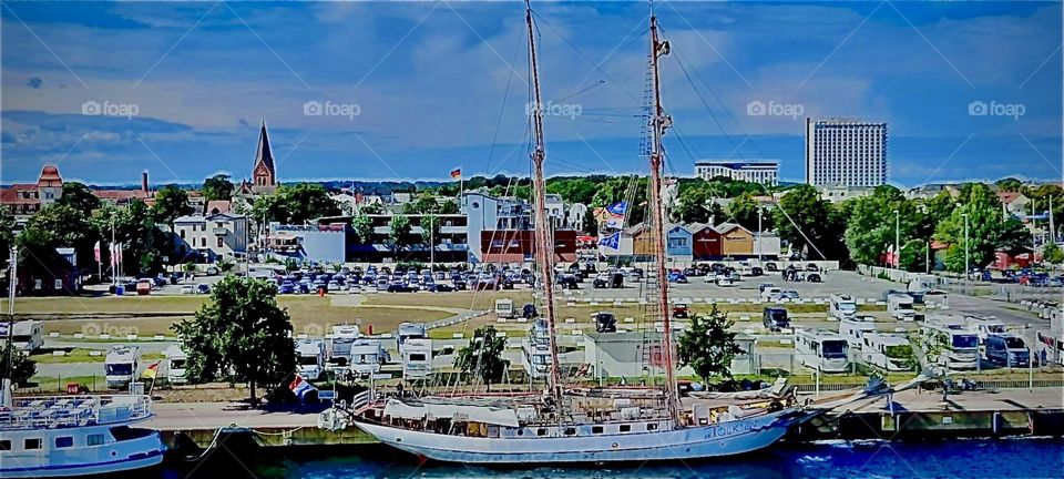 Ships at the harbor in „Rostock“, Germany by the „Baltic Sea“ or the „Oatsee“ as she is known to speakers of the German tongue. With the masts down some of these sailing giants such as the „Tolkien“ appear much smaller. 2022. Hypnotic Productions