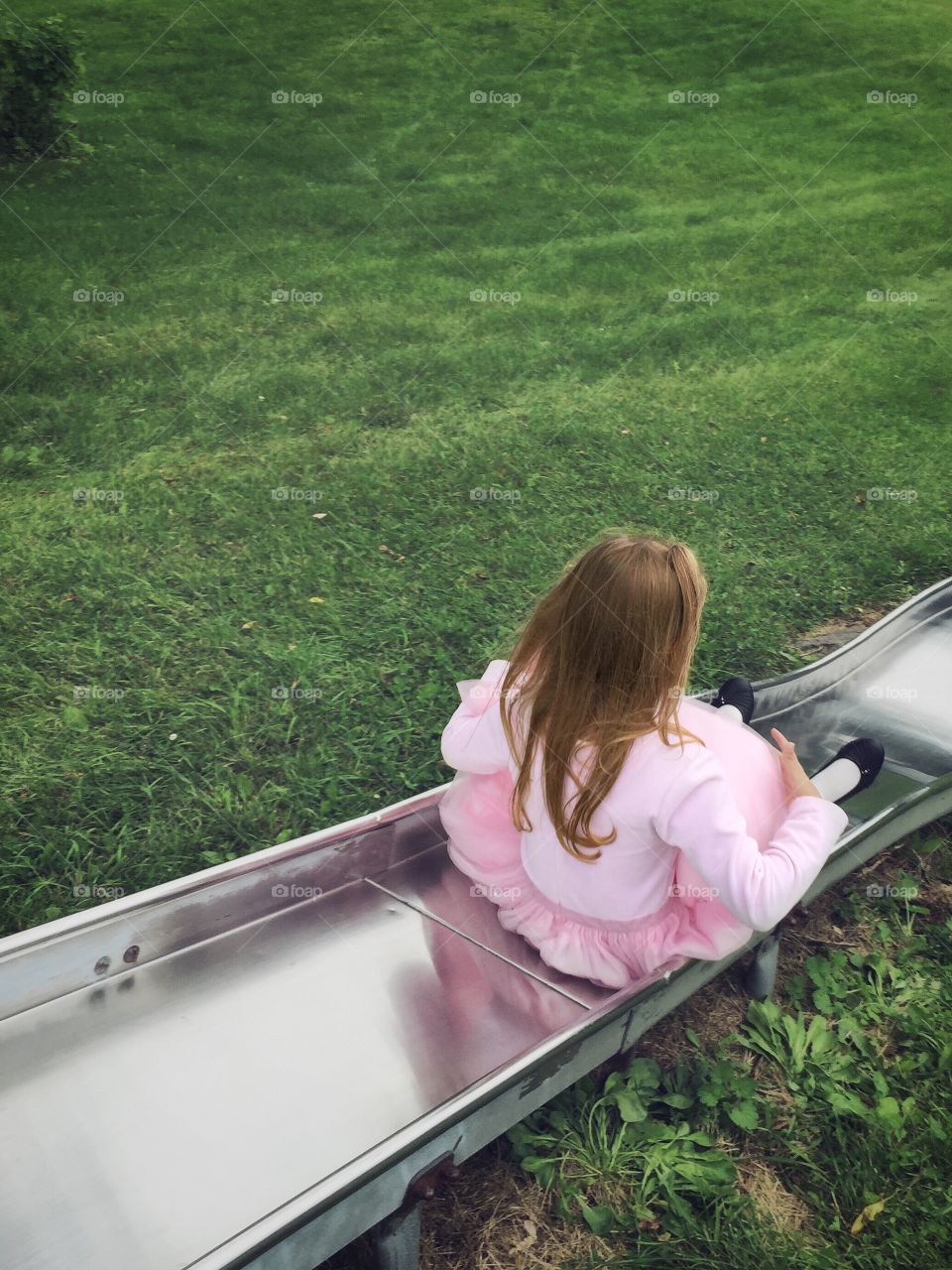 Rear view of girl on slide