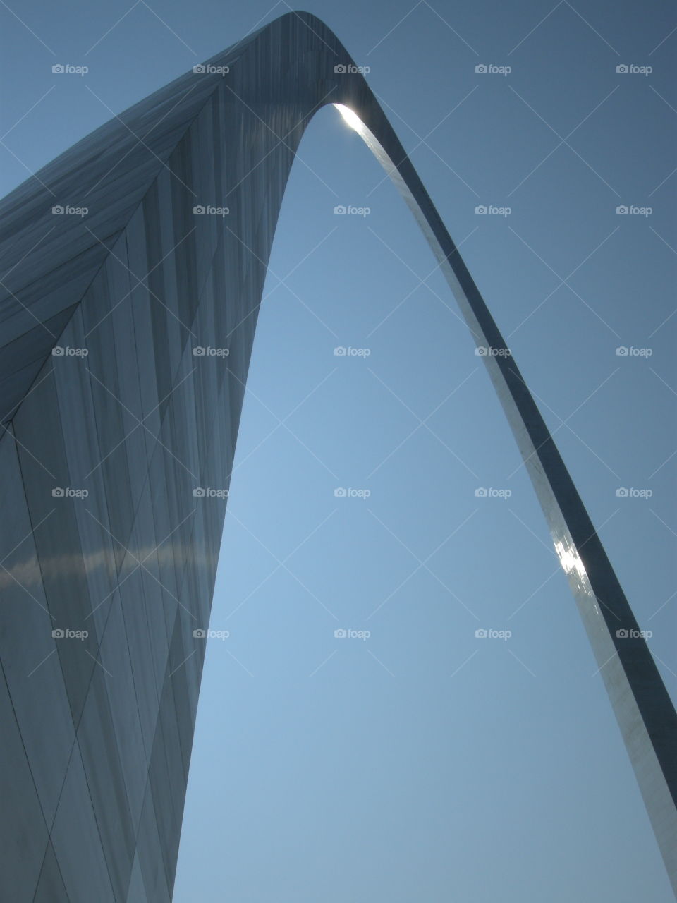 The afternoon sun glints on the stainless steel skin of the Gateway Arch in St. Louis