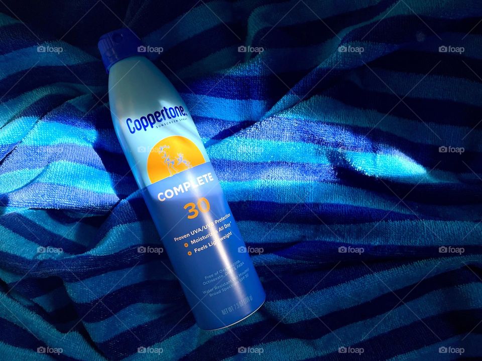 Sun protection spray on the towel