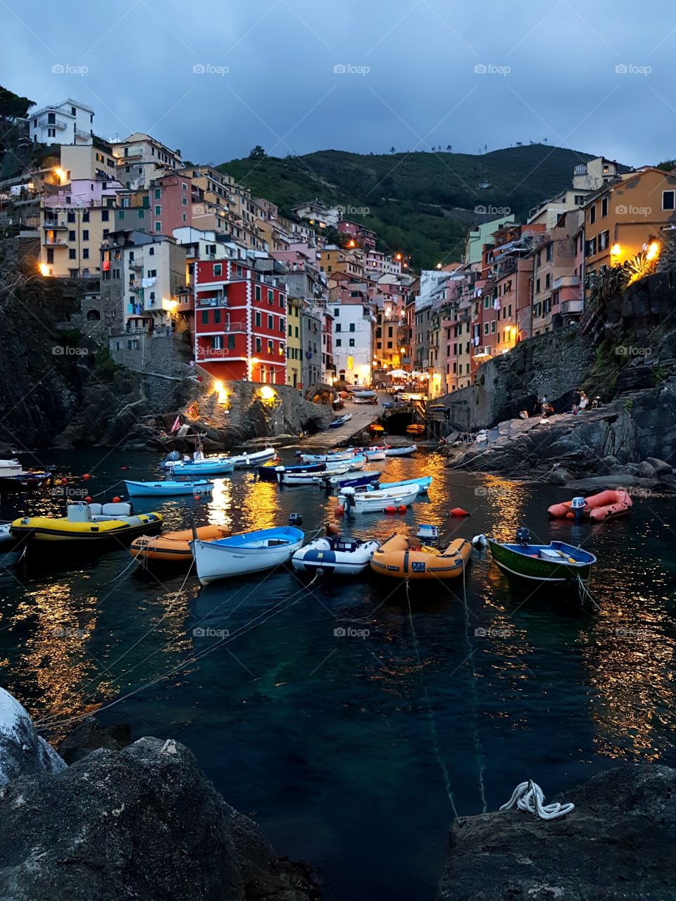 View of the boats in the marina at Riomaggiore on sunset