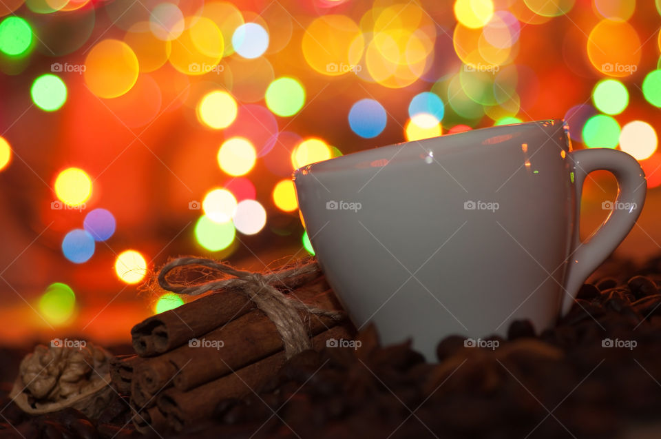 Cup of coffee on christmas light background