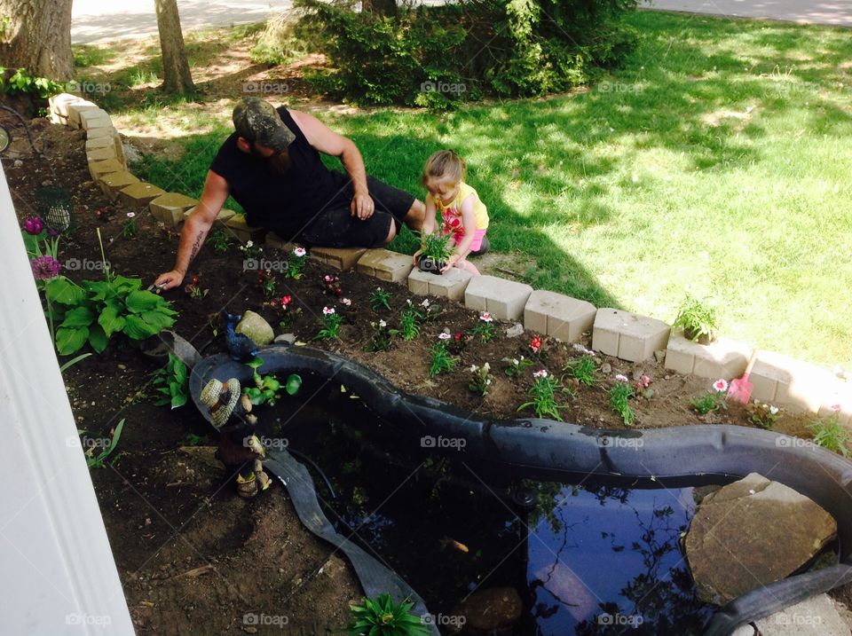 Gardening. My ex husband and our daughter working in the garden. 