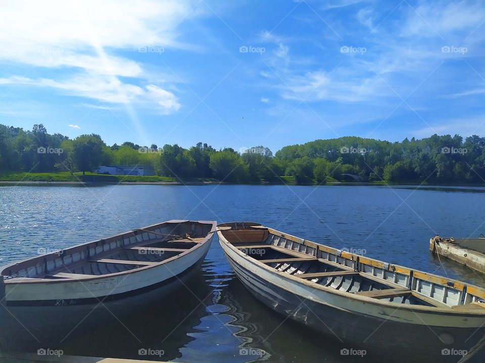 Two boats that are tied to the shore