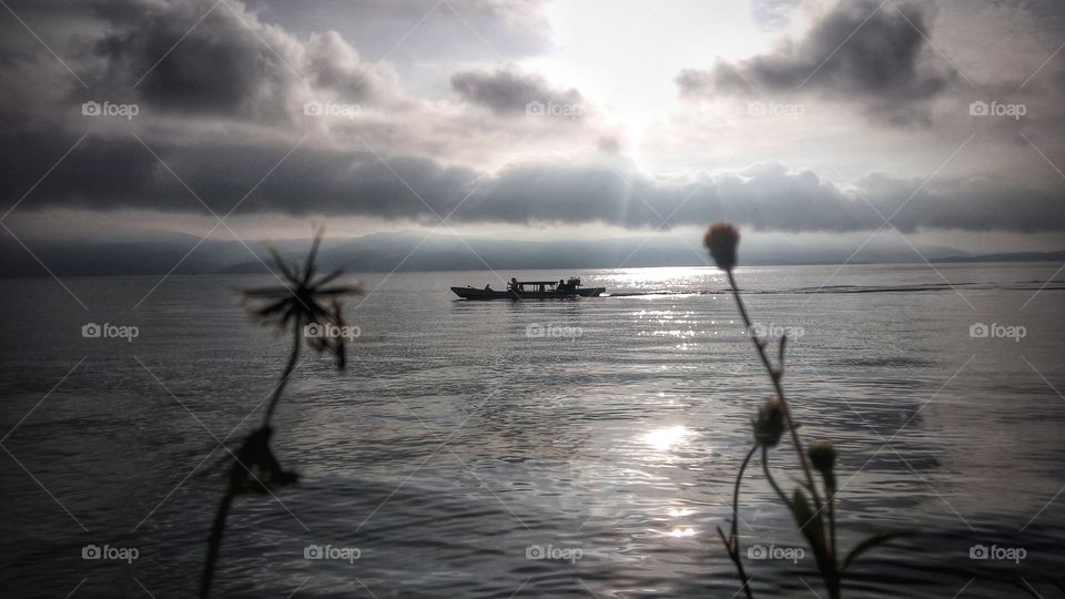 Scenic view of sea against cloudy sky