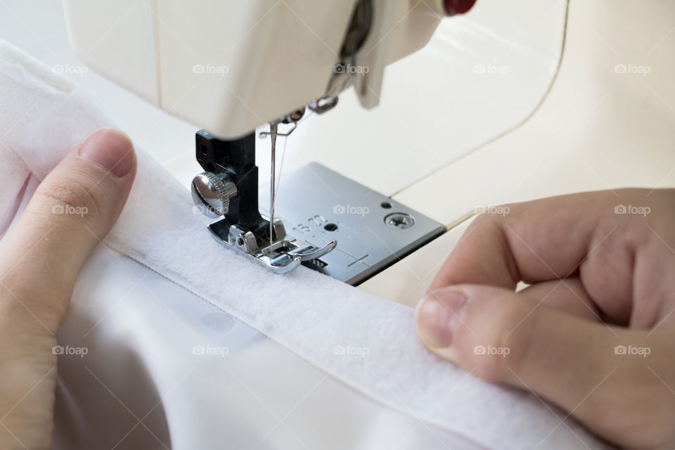 Woman sewing on the sewing machine