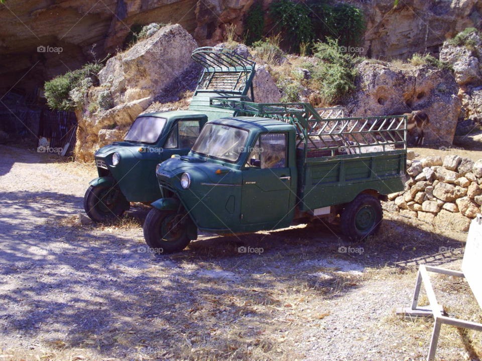 small trucks at lindos rhodes parked in a rocky area by pawright68