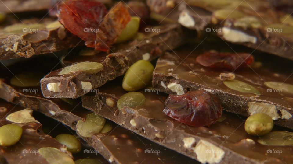 Close-up of dark chocolate bark with sunflower seeds and cranberries