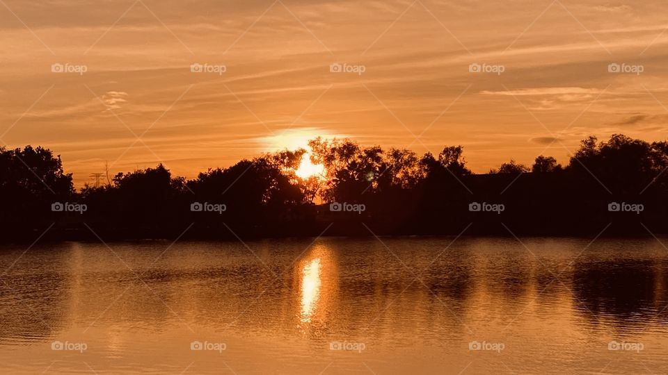 As I draw pics closer now we have deep Orange Colours, still blended with all the colours and the Sun’s Reflection even cast a shadow on the lake. Very strong and powerful Sunset today. 