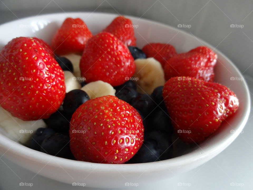 Healthy fruits breakfast full of vitamins with strawberry, banana and berries