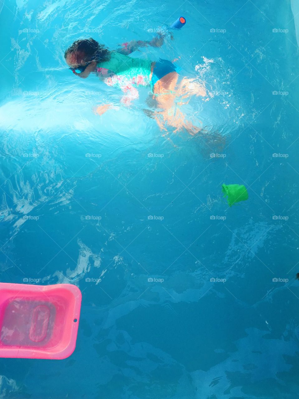 Child swimming in the pool on a summer day in Brazil