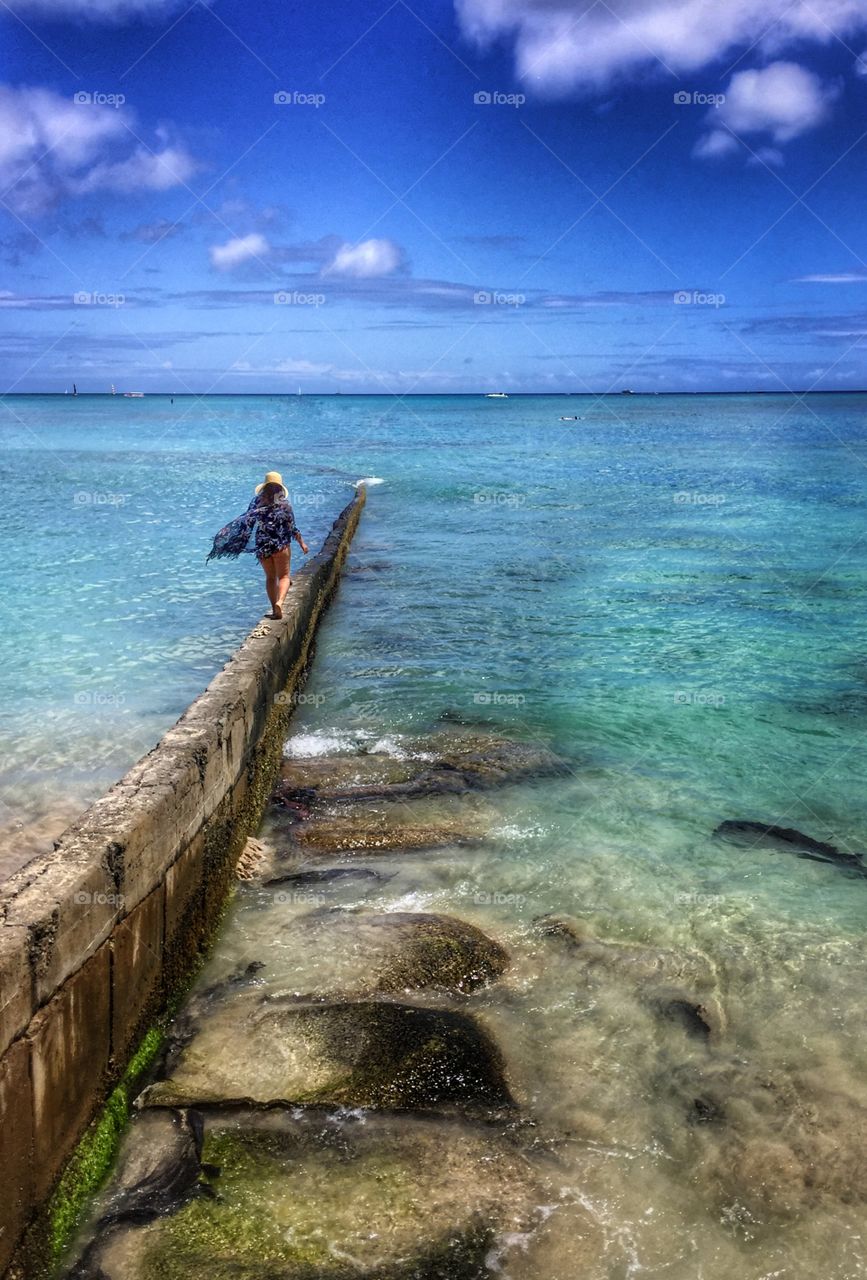 Woman walking on seawall