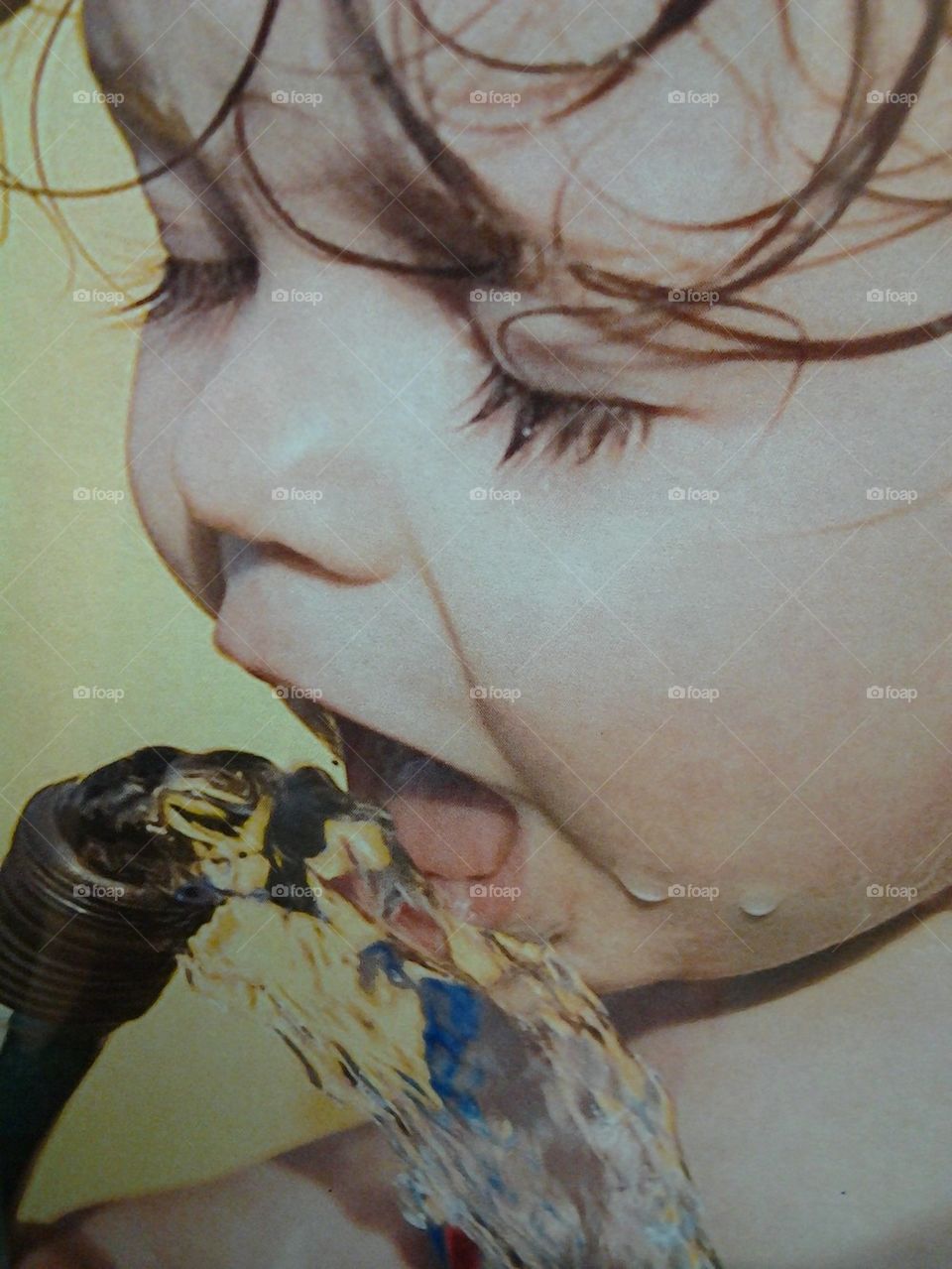 girl drinking from hose