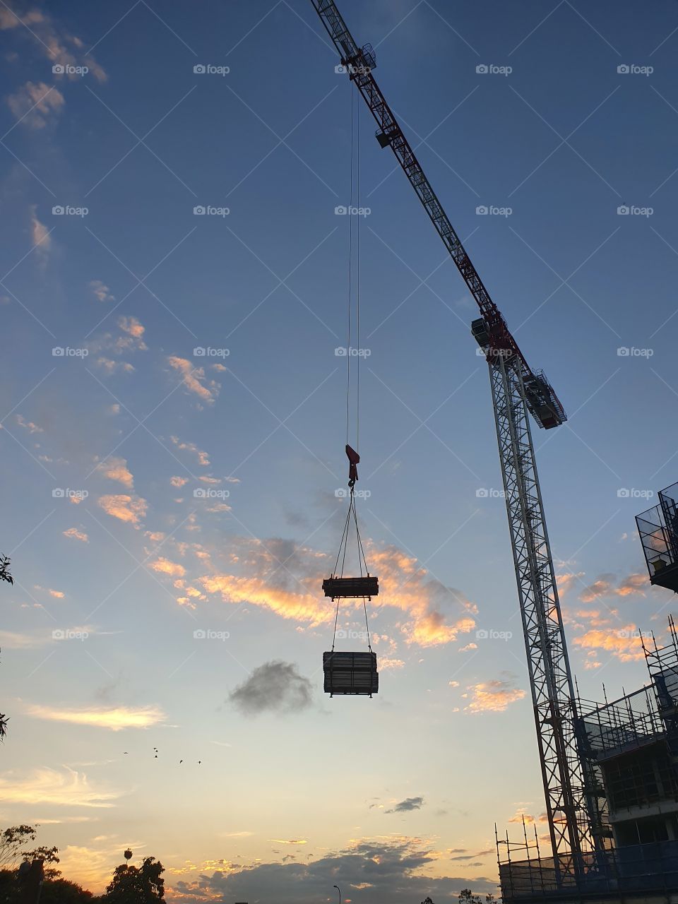 Crane at work at sunset