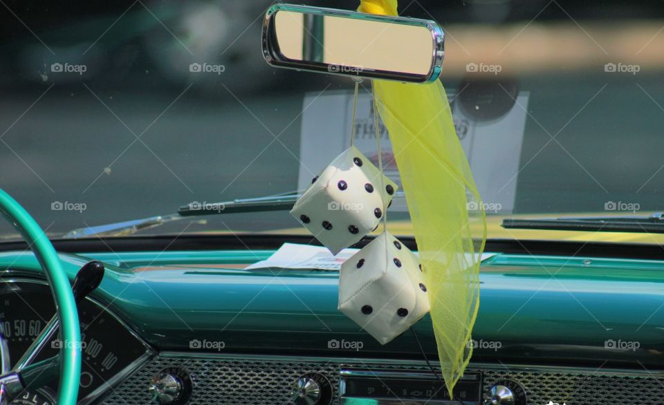 Dice hanging on classic car.