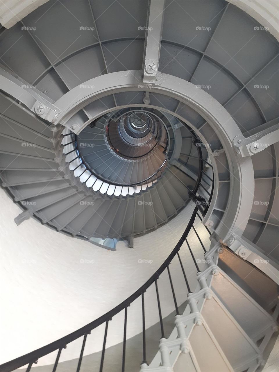 The steep spiral staircase of the Ponce Inlet Lighthouse in Ponce Inlet, Florida. Photo taken from below.