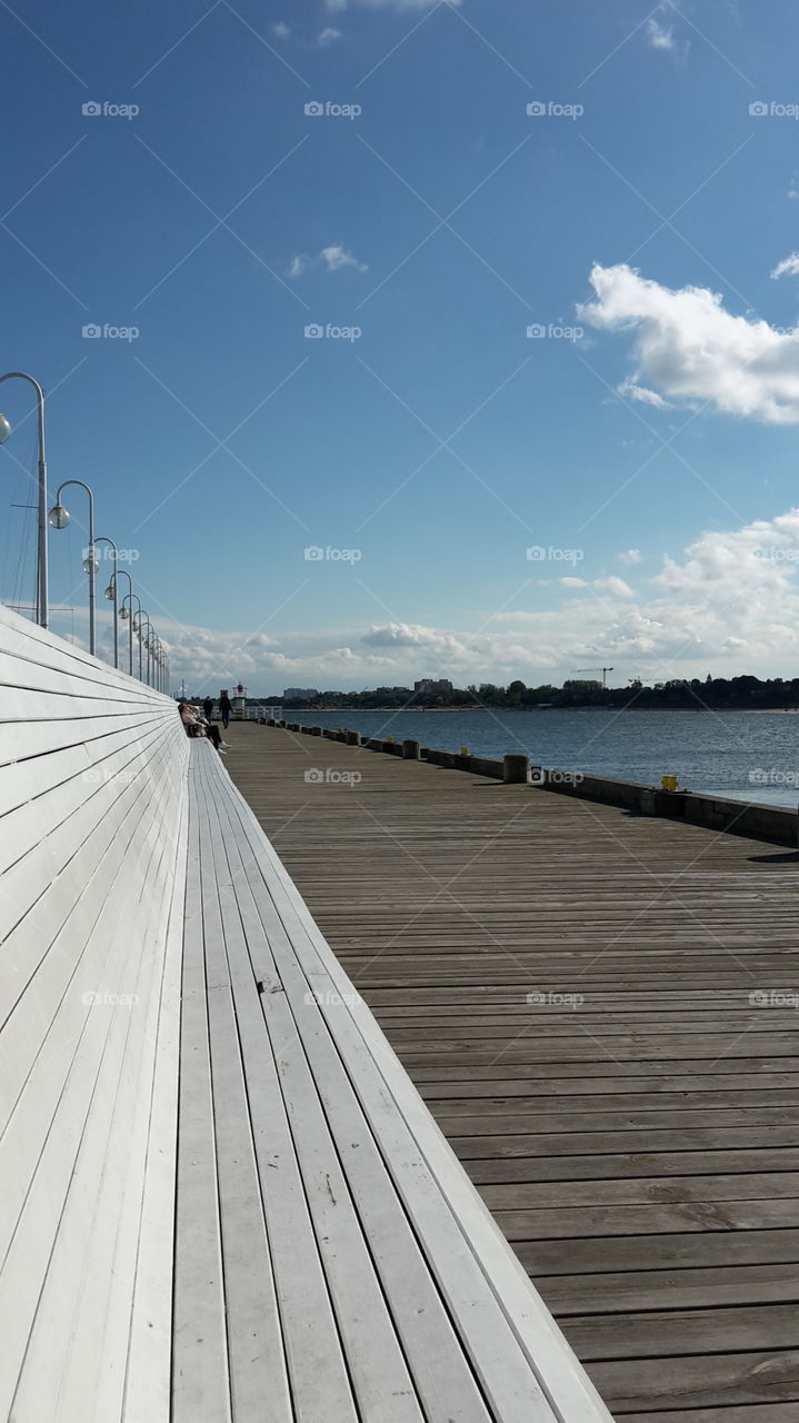 white wooden pier bank at Baltic sea in sunny autumn holidays day