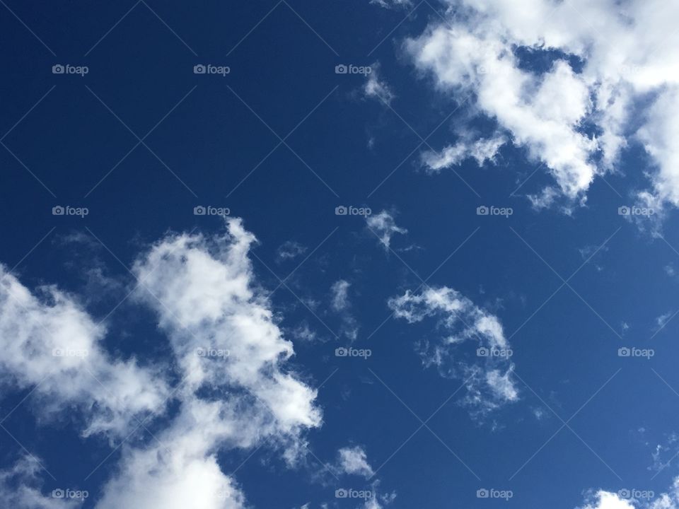 Blue sky with clouds on the sunny day.