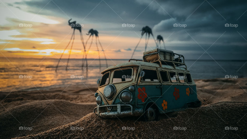 minivan stands on the beach, sunset time.  Beach episode on Phu Quoc. Elephants on long legs in the water