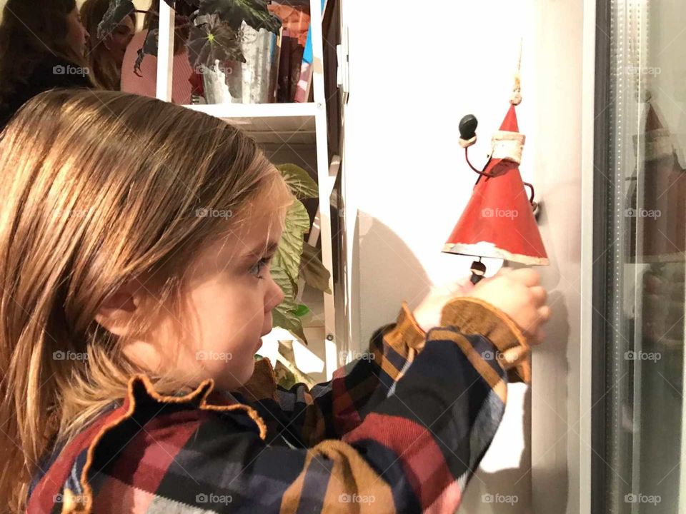Little girl playing with Christmas decorations