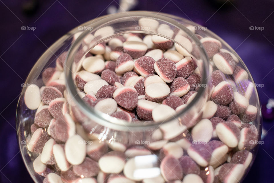 Purple and white candy in candy bowl