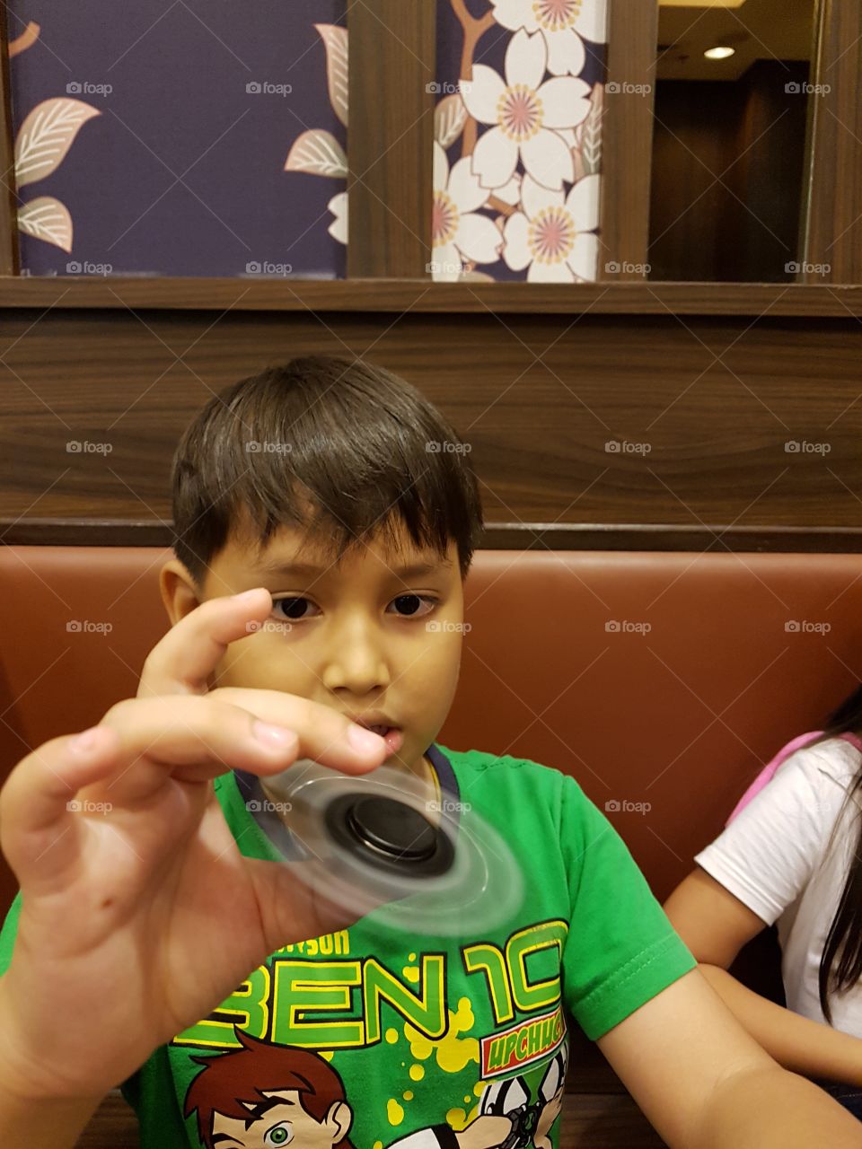 young boy playing new finger toy spinner