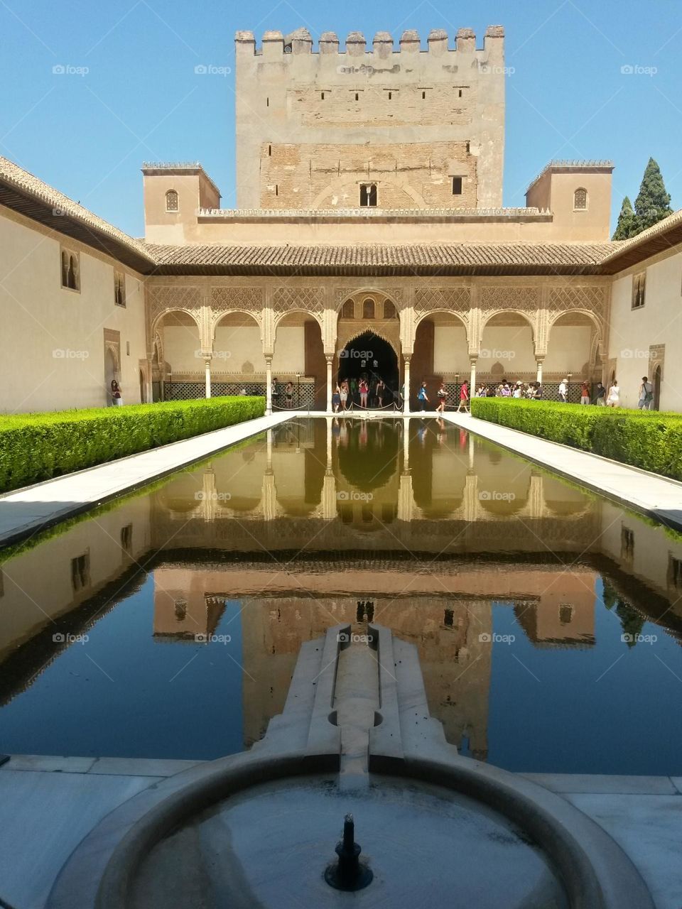 Architectural reflections inside the Alhambra in Granada, Spain. Clear sky.