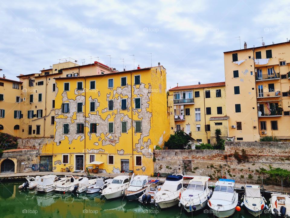 yellow house with many windows in the historic center of Livorno in Italy