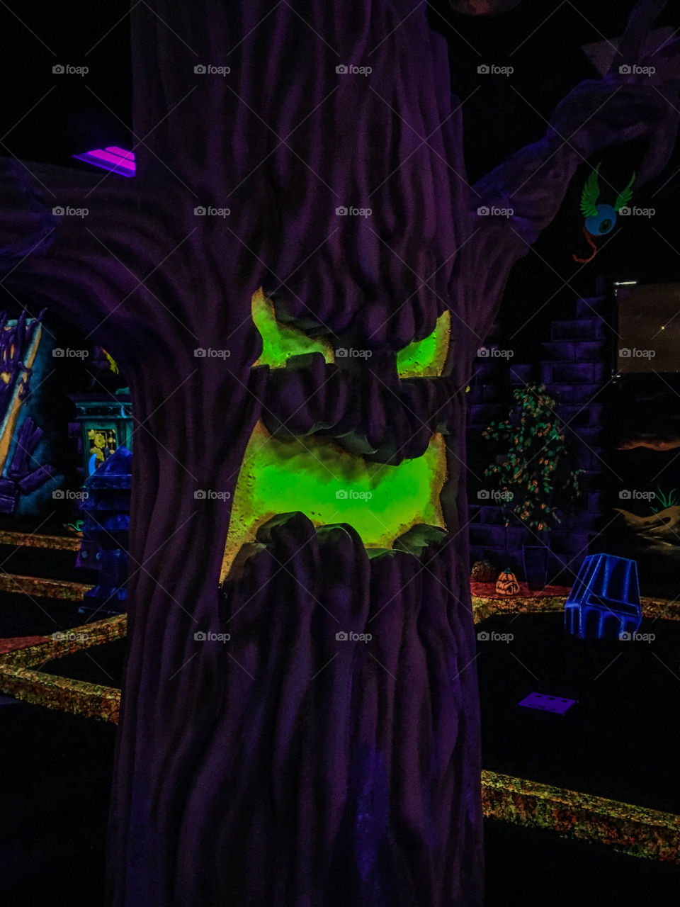 Spooky tree in the middle of an indoor miniature golf course called Monster Mini Golf 