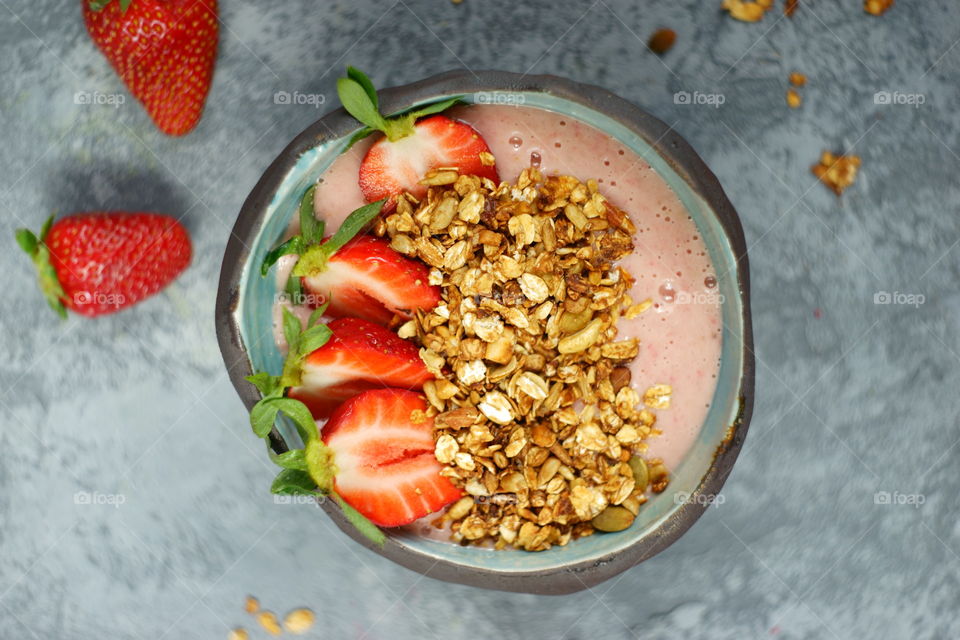 Fresh smoothie bowl with strawberry and granola
