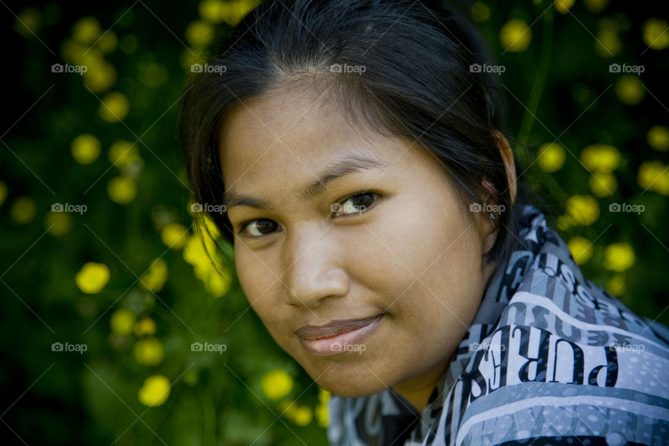 Beautiful Asia lady enjoying spring. portrait of Sriwan with blooming flowers