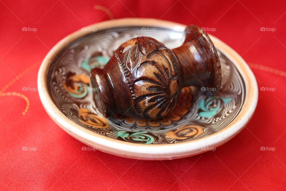 miniature clay pot sitting on traditional plate