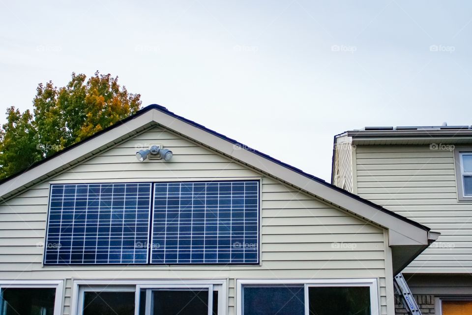 Alternative energy home solar panels in fall.