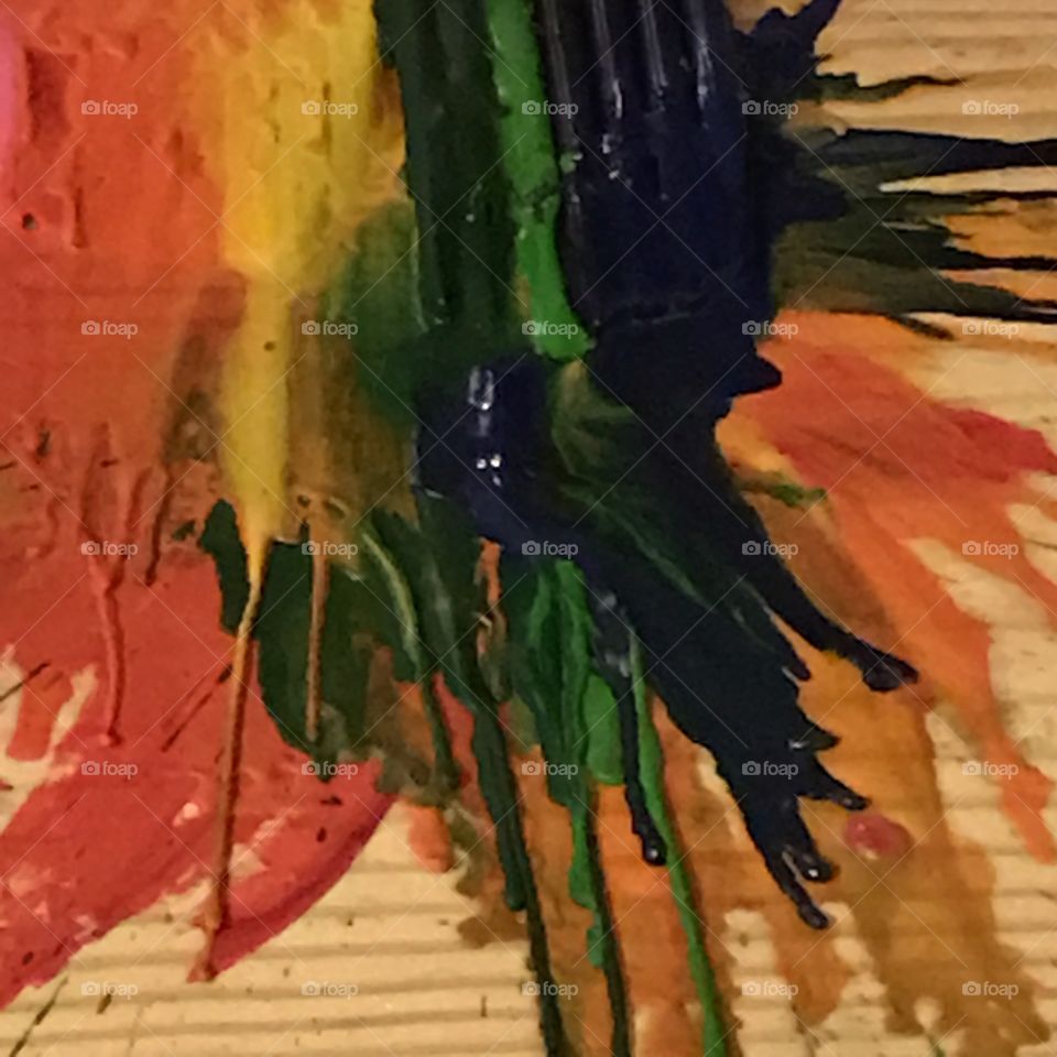 Using a hair dryer to melt different colors of crayons splatters the colors making an abstract painting.