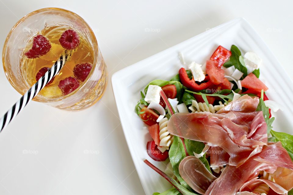 Close-up of meat salad with raspberry juice