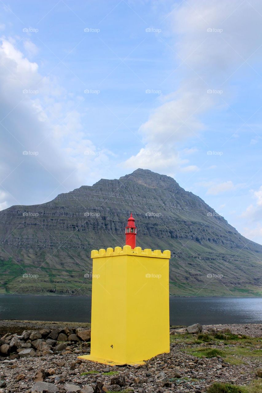 A small yellow lighthouse