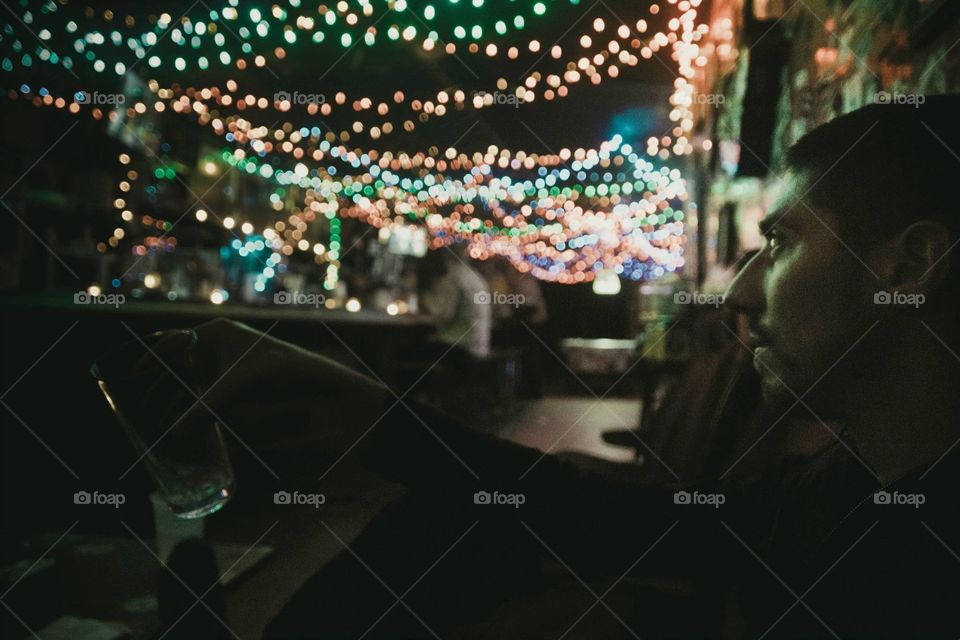 Staring lights in trashy bar. Still staring the lights while holding the empty glass at a trashy bar in Willamsburg, NYC