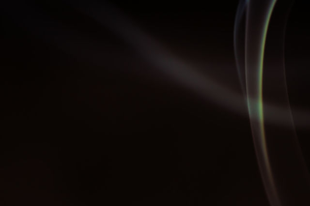 Smoke scented candles on a black background