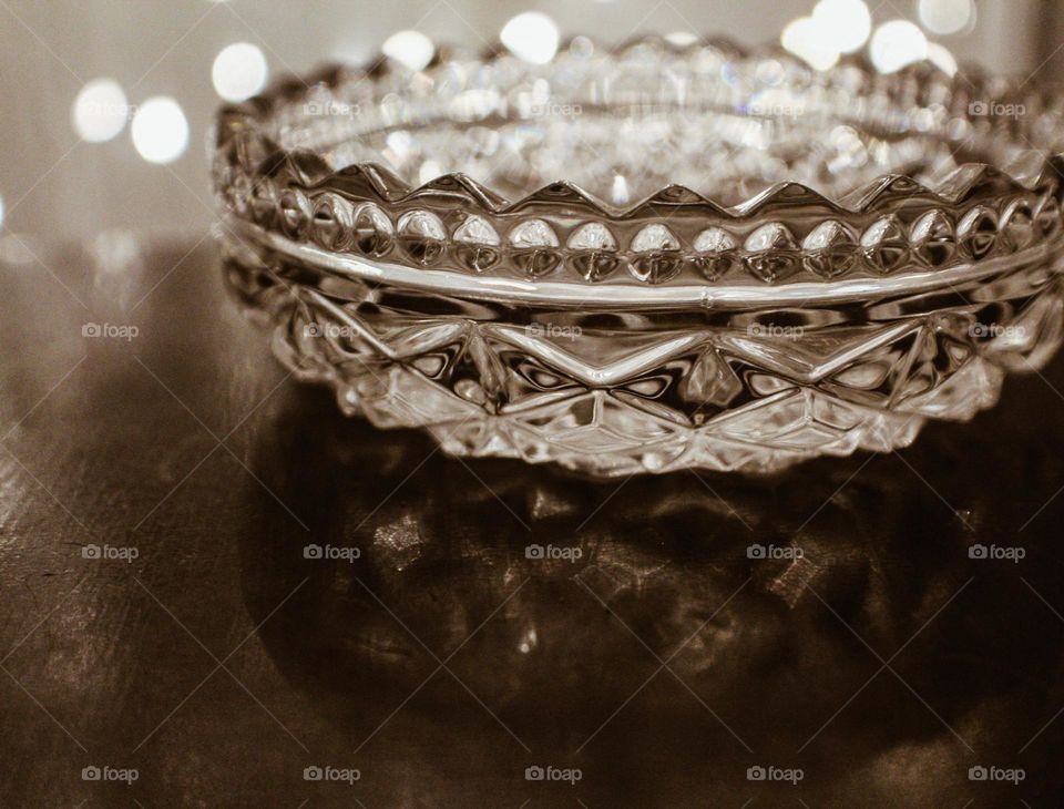 A glass dish is illuminated by the lights behind it, it’s unique pattern on display